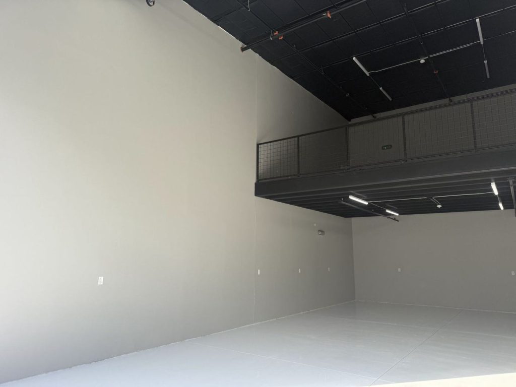 Finished commercial space with painted walls and a black mezzanine