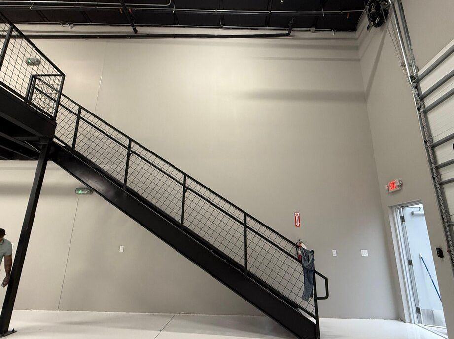 Painted commercial space walls beside a steel staircase