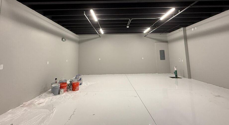 Commercial warehouse with black ceiling and gray painted walls