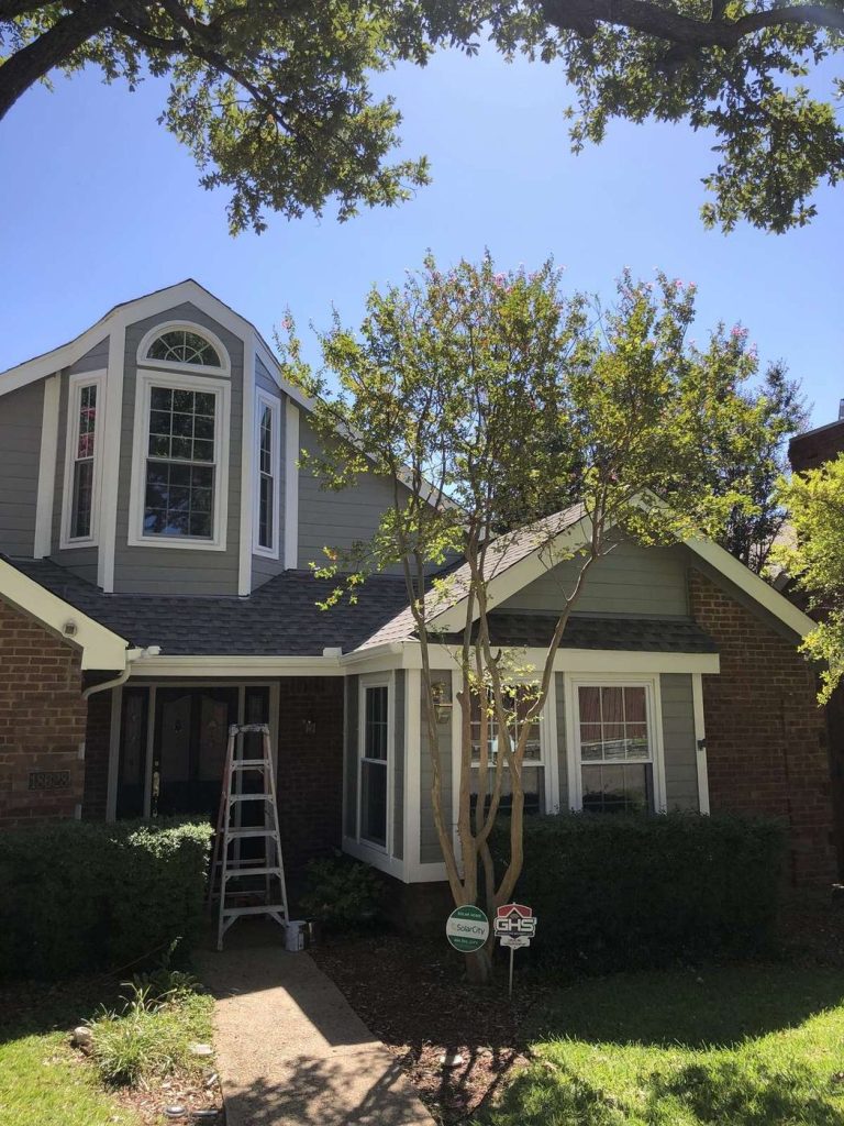 Front of a brick and gray siding home after exterior painting