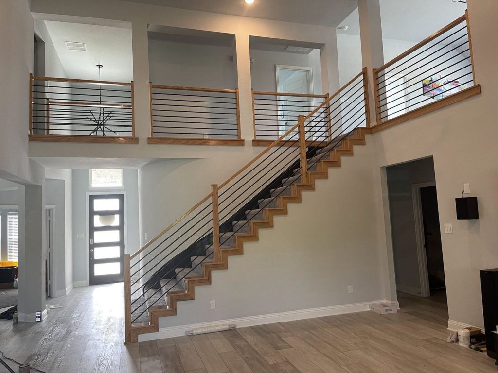 Refinished modern staircase with horizontal cable-style railing