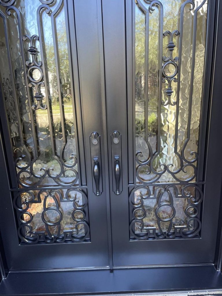 Close-up of painted iron door scrollwork