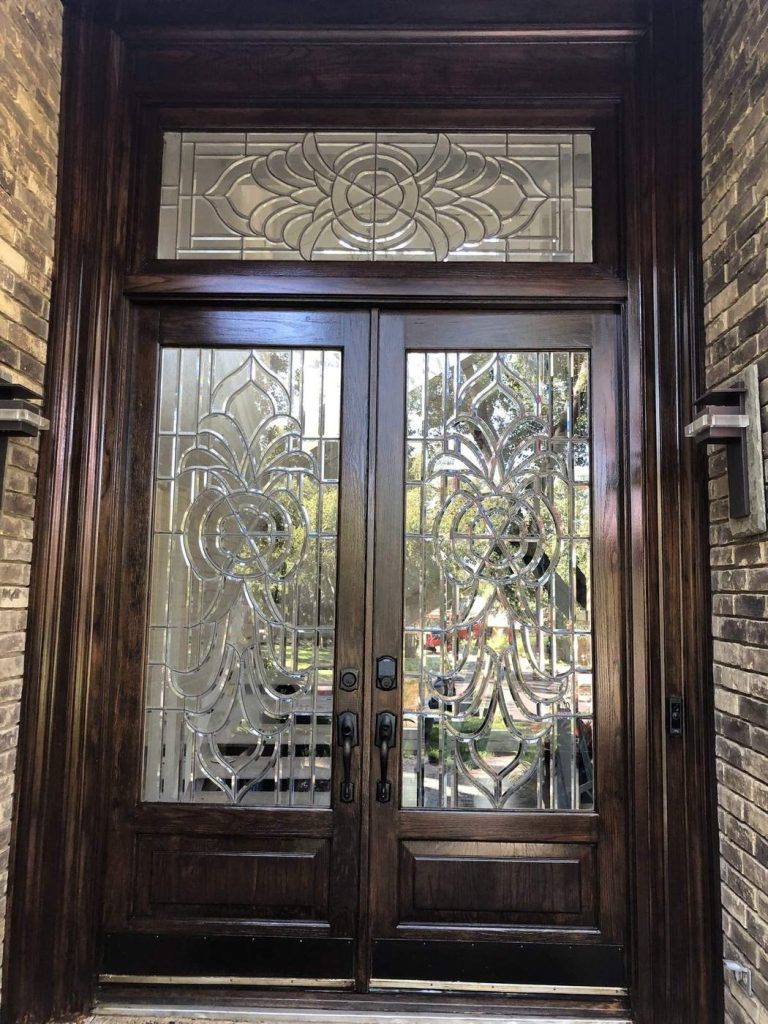 Dark stained double entry doors with decorative glass