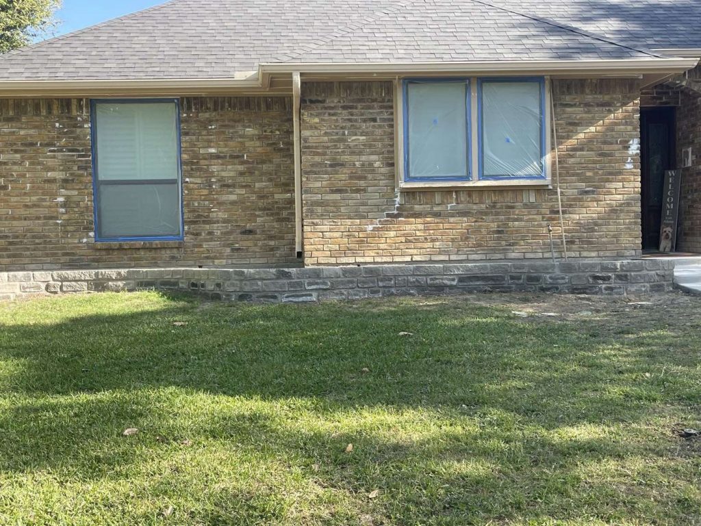Windows masked and protected before painting exterior brick
